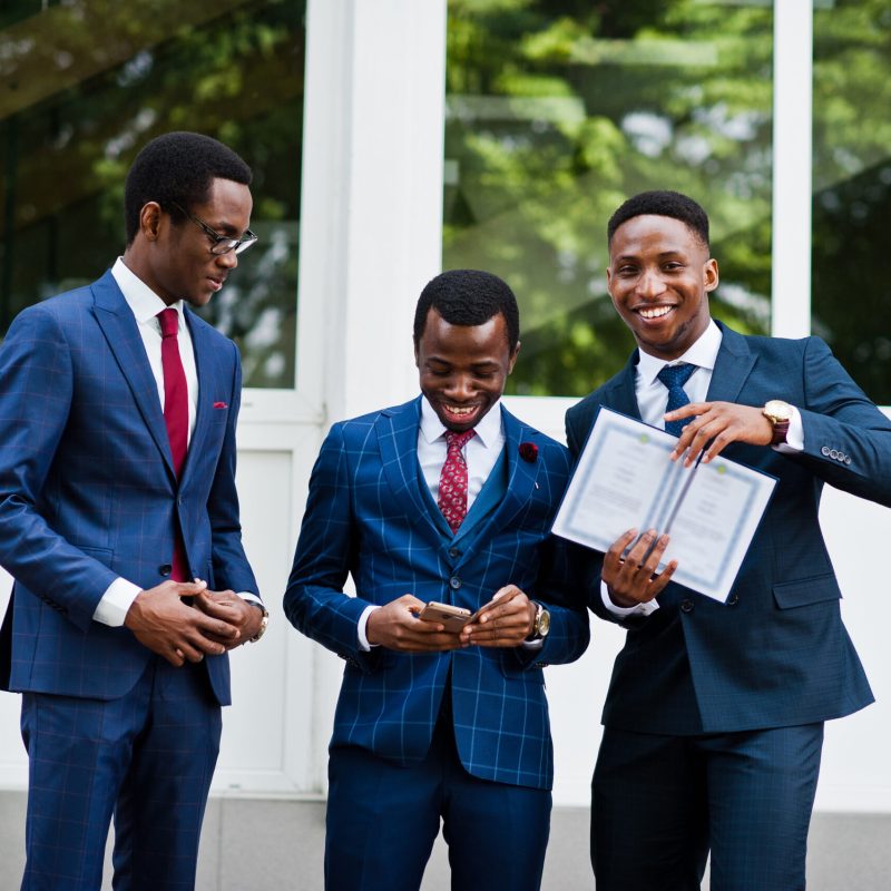 Three african american happy successful mans at suit with diploma at graduation day.